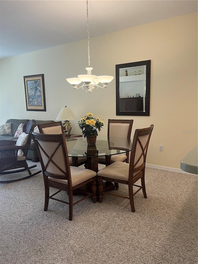 carpeted dining room with a chandelier