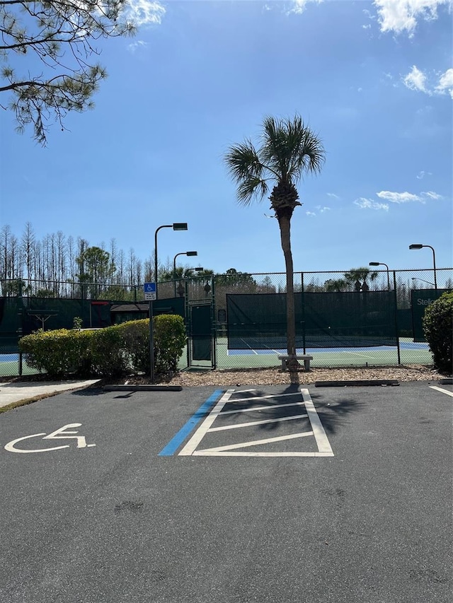 view of parking / parking lot with tennis court