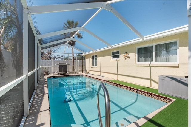 view of swimming pool featuring a lanai