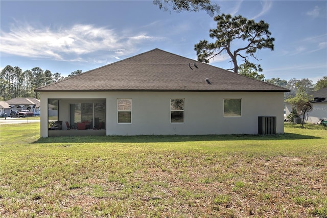 11134 Horned Owl Rd, Weeki Wachee, FL 34614 - rear view of property featuring a yard, a shingled roof, and stucco siding