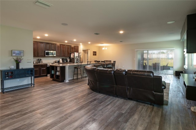 11134 Horned Owl Rd, Weeki Wachee, FL 34614 - living area with wood finished floors, visible vents, and recessed lighting