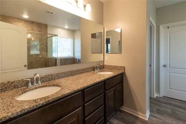 11134 Horned Owl Rd, Weeki Wachee, FL 34614 - bathroom with a shower stall, wood finished floors, a sink, and double vanity