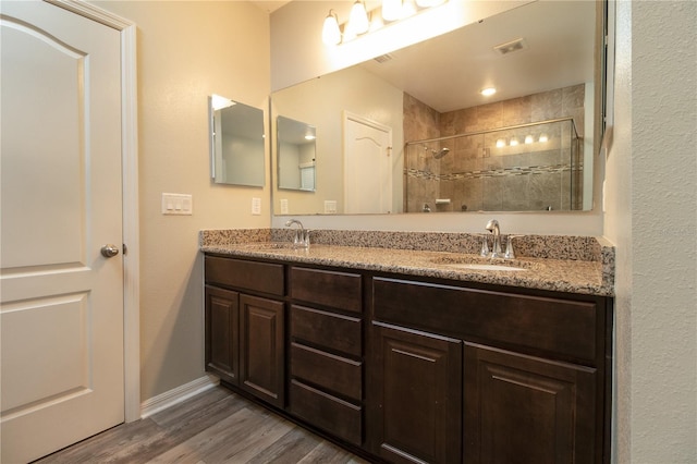 11134 Horned Owl Rd, Weeki Wachee, FL 34614 - full bathroom featuring wood finished floors, a sink, visible vents, and tiled shower