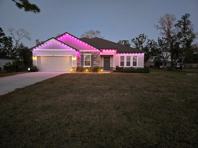 11134 Horned Owl Rd, Weeki Wachee, FL 34614 - view of front of house with concrete driveway, an attached garage, stone siding, and a front yard