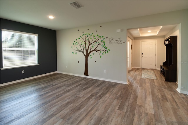11134 Horned Owl Rd, Weeki Wachee, FL 34614 - spare room with visible vents, a raised ceiling, baseboards, dark wood-style floors, and recessed lighting