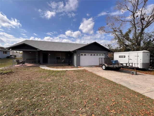 view of front facade featuring a garage, a porch, and a front yard