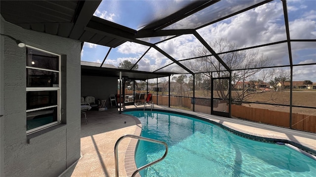 view of swimming pool with a patio and glass enclosure