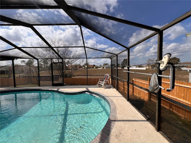 view of swimming pool featuring a lanai, a patio area, a fenced backyard, and a fenced in pool