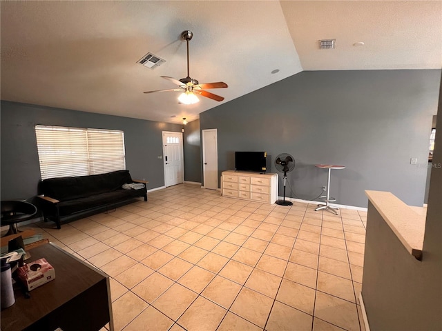 living area with light tile patterned floors, ceiling fan, visible vents, baseboards, and vaulted ceiling