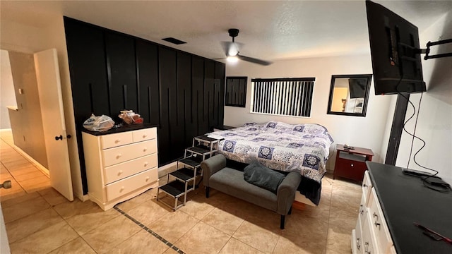 bedroom with a ceiling fan and light tile patterned flooring