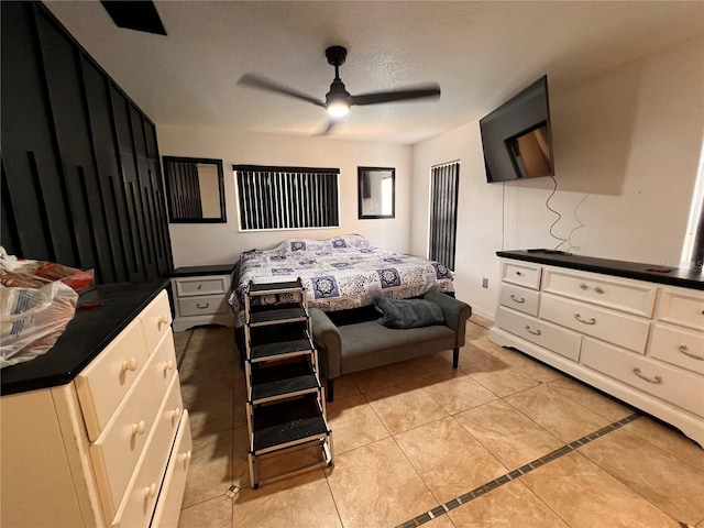 bedroom featuring a textured ceiling and ceiling fan