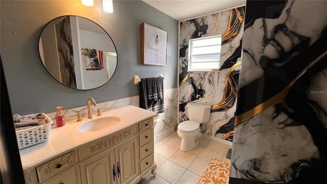 full bathroom with toilet, vanity, and tile patterned floors