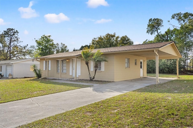 ranch-style home featuring a carport, driveway, and a front lawn