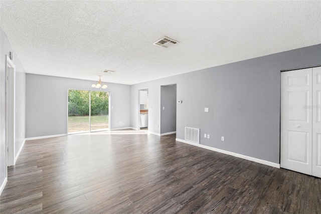 spare room featuring dark wood-type flooring, visible vents, and baseboards