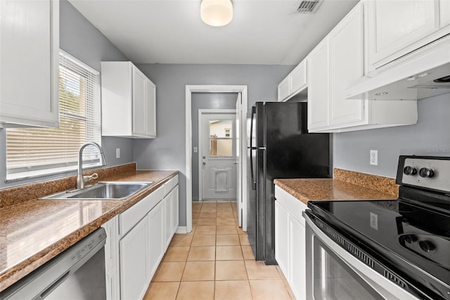 kitchen with light tile patterned floors, appliances with stainless steel finishes, white cabinets, a sink, and under cabinet range hood