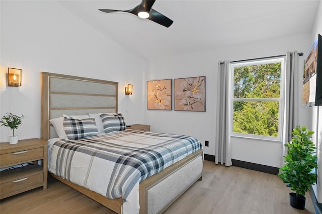 bedroom with lofted ceiling, ceiling fan, and light hardwood / wood-style flooring