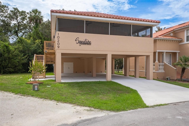 10209 W Waterlander Loop Unit 164, Homosassa, FL 34448 - view of front of property with a carport, a tile roof, a sunroom, driveway, and stucco siding