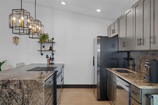 10209 W Waterlander Loop Unit 164, Homosassa, FL 34448 - kitchen with stainless steel appliances, light wood-type flooring, backsplash, gray cabinets, and recessed lighting