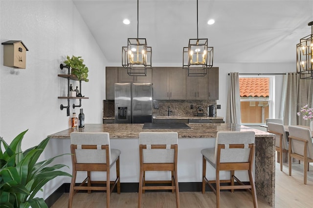 10209 W Waterlander Loop Unit 164, Homosassa, FL 34448 - kitchen with stainless steel fridge with ice dispenser, tasteful backsplash, light wood-style floors, a chandelier, and recessed lighting