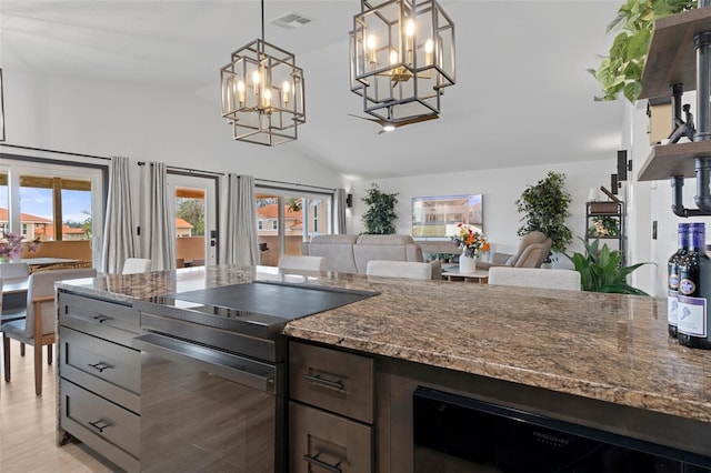 10209 W Waterlander Loop Unit 164, Homosassa, FL 34448 - kitchen featuring black appliances, a chandelier, plenty of natural light, dark stone countertops, and vaulted ceiling