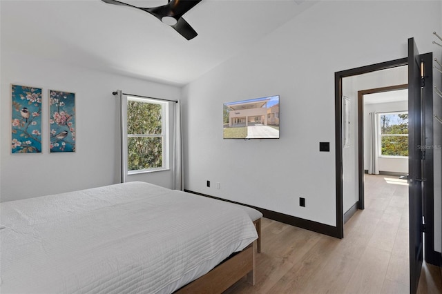10209 W Waterlander Loop Unit 164, Homosassa, FL 34448 - bedroom featuring multiple windows, lofted ceiling, light wood-style flooring, and ceiling fan