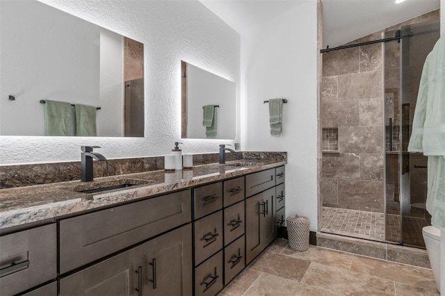 10209 W Waterlander Loop Unit 164, Homosassa, FL 34448 - bathroom featuring a shower stall, double vanity, and stone finish flooring
