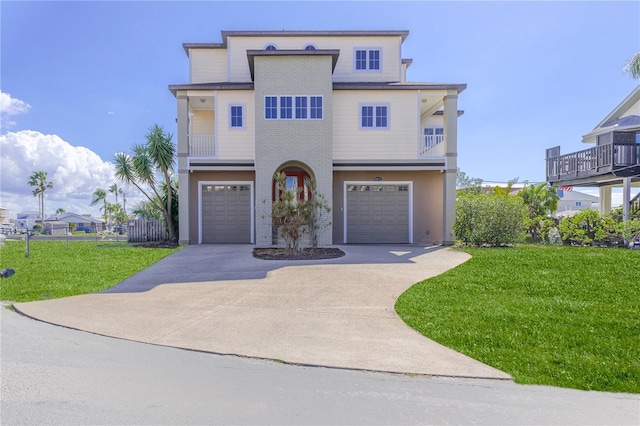 view of front of home featuring a garage, a front yard, and a balcony