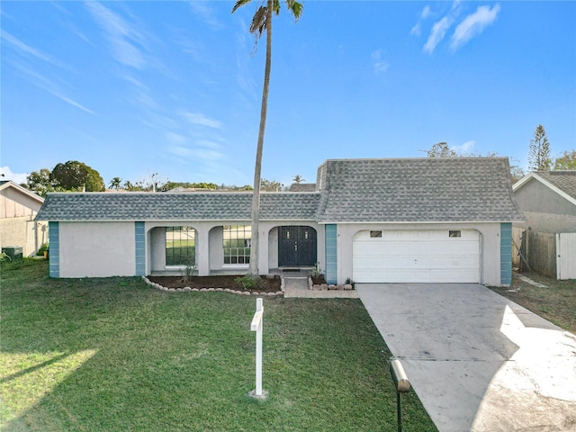 ranch-style home with a garage and a front lawn