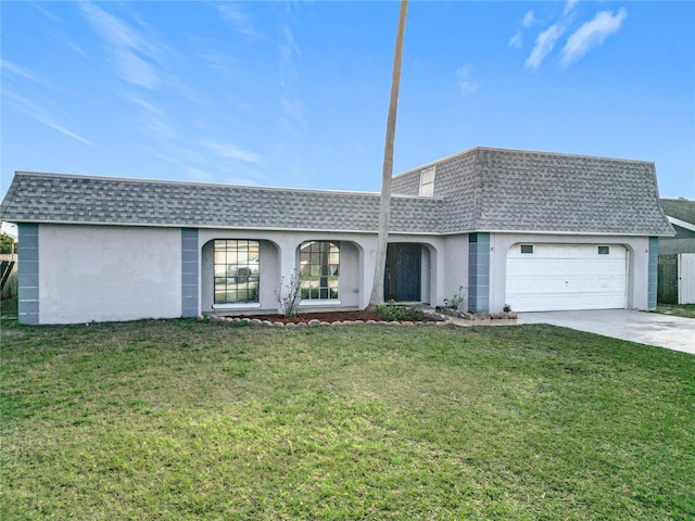 single story home with a garage and a front lawn