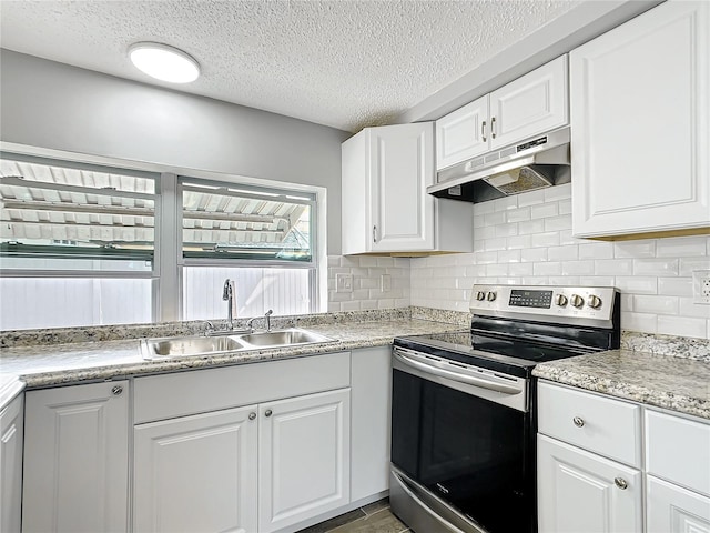 kitchen with tasteful backsplash, sink, white cabinets, electric range, and a textured ceiling