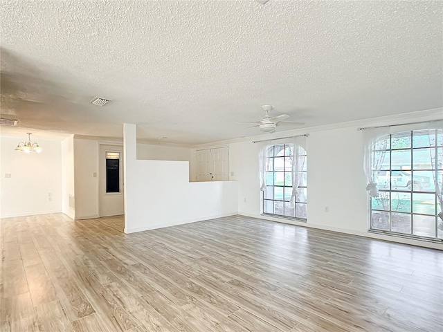 unfurnished room with ceiling fan with notable chandelier, a textured ceiling, and light hardwood / wood-style flooring