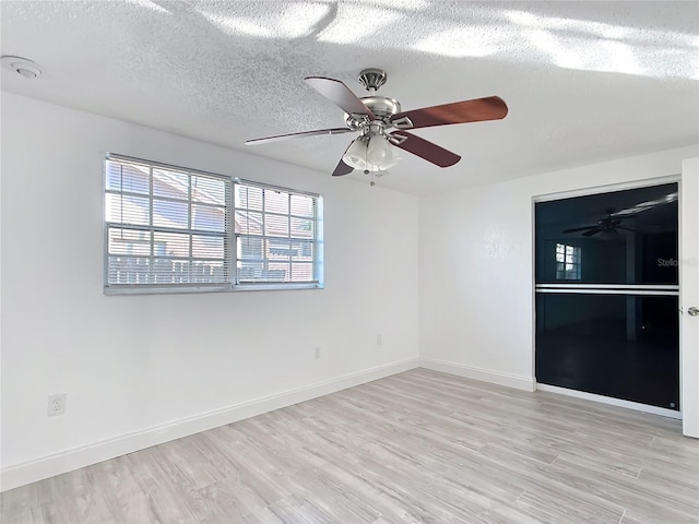 unfurnished room featuring ceiling fan, a textured ceiling, and light hardwood / wood-style flooring