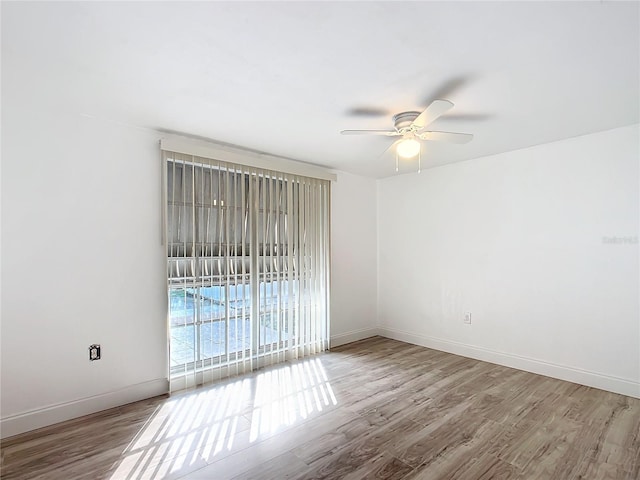 spare room with hardwood / wood-style floors and ceiling fan