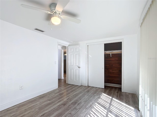 unfurnished bedroom featuring light hardwood / wood-style flooring, a closet, and ceiling fan