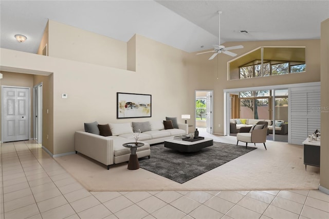 tiled living room featuring high vaulted ceiling and ceiling fan