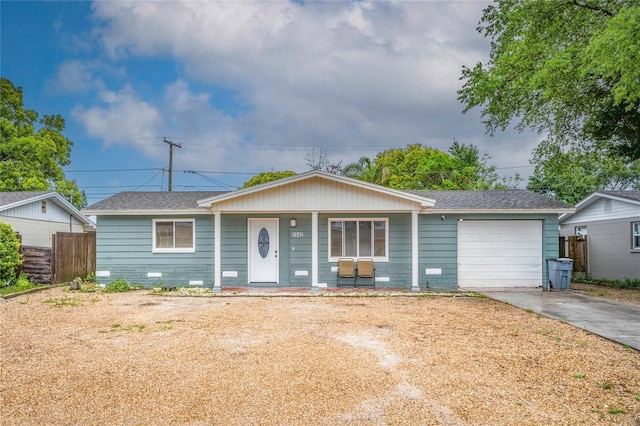 ranch-style house with a garage and covered porch