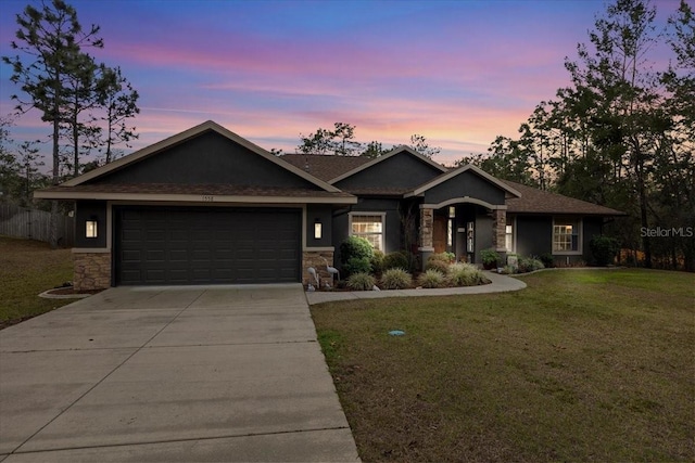 craftsman-style house featuring a garage and a lawn