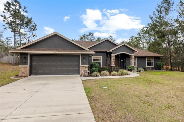 view of front of home featuring a garage and a front lawn