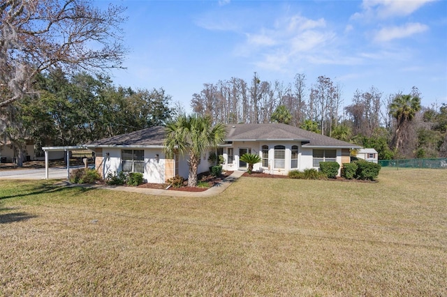 ranch-style house with a carport and a front yard