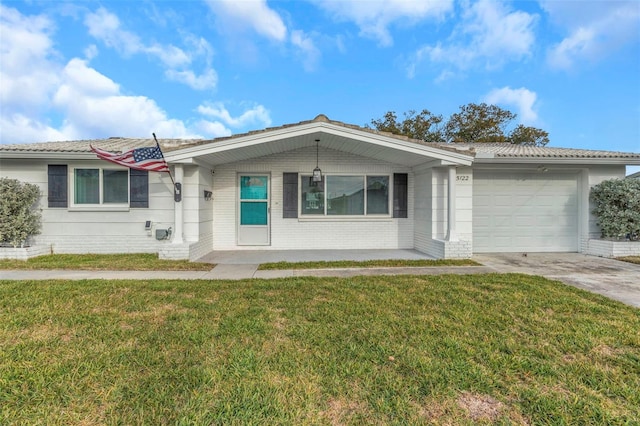 ranch-style house featuring a garage and a front yard