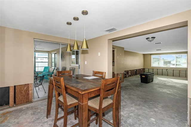 dining space with plenty of natural light and concrete flooring