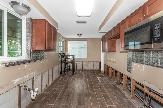 kitchen featuring tasteful backsplash and dark wood-type flooring