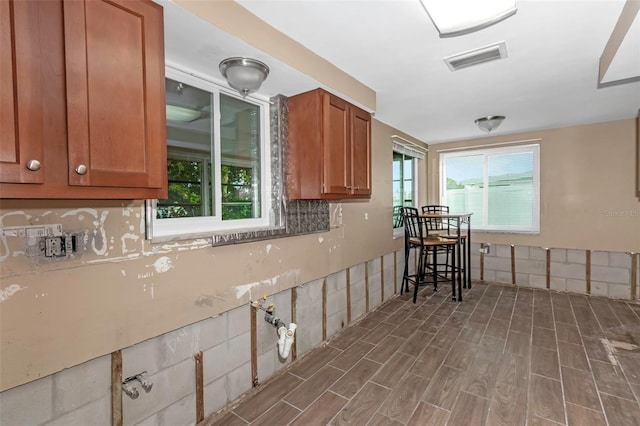 kitchen with decorative backsplash and dark wood-type flooring