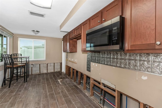 kitchen featuring backsplash and dark hardwood / wood-style floors