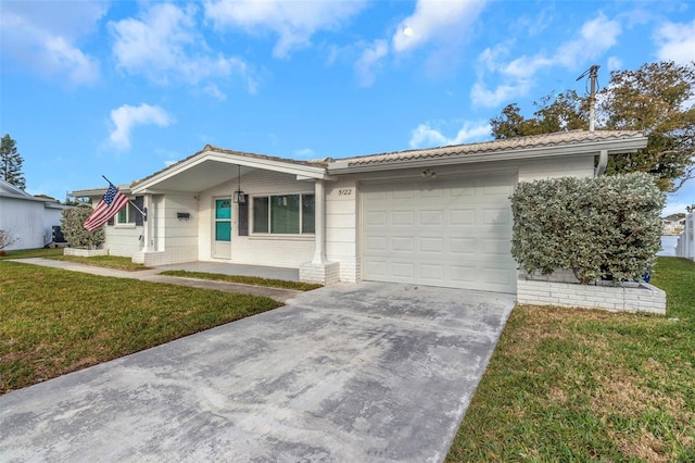 single story home with a garage and a front lawn