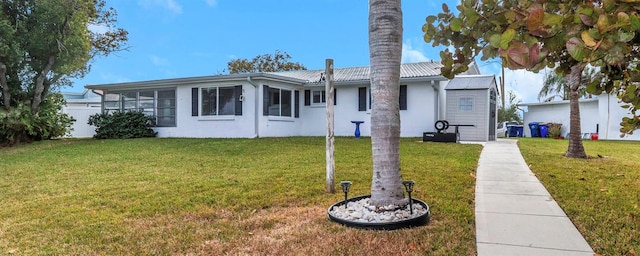 rear view of house featuring a lawn