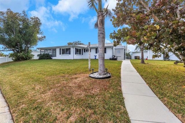 single story home featuring a front lawn