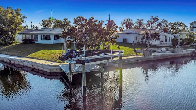 dock area featuring a water view and a lawn