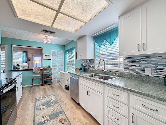 kitchen featuring range with electric stovetop, visible vents, light wood-style floors, a sink, and dishwasher