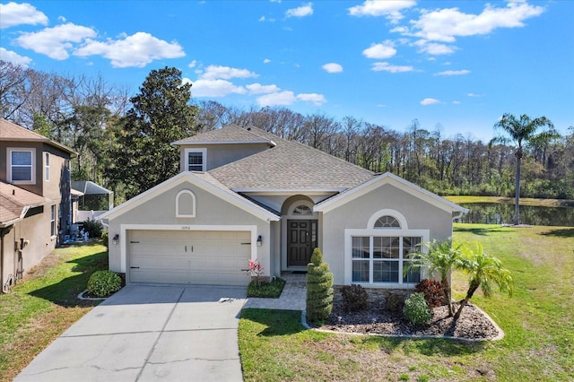 ranch-style home with a garage, concrete driveway, roof with shingles, and a front yard